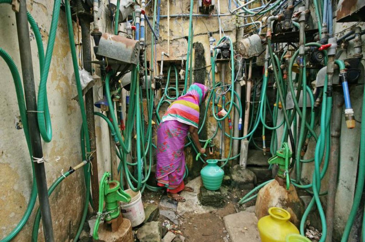 A woman uses a hand pump to fill up a container with drinking water in Chennai, as the city's water supplies ran low, India, June 25. Reuters/P. Ravikumar