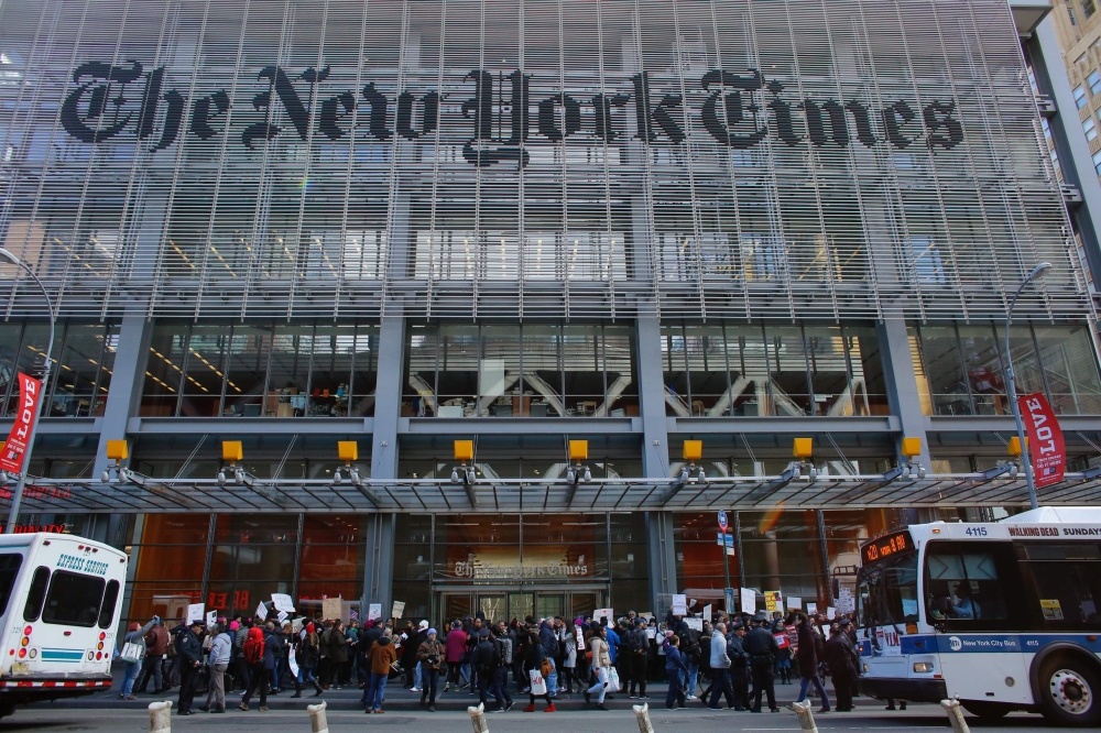 In this file photo taken on February 26, 2017, people take part in a protest outside the New York Times in New York. AFP / Kena Betancur