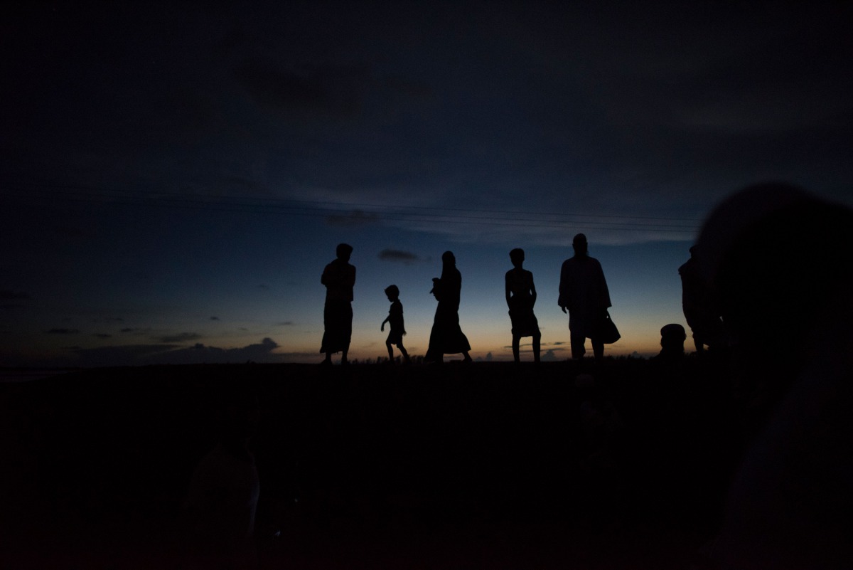 In this picture taken on October 1, 2017, Bangladeshi people wait for boats in Teknaf. AFP/Fred Dufour