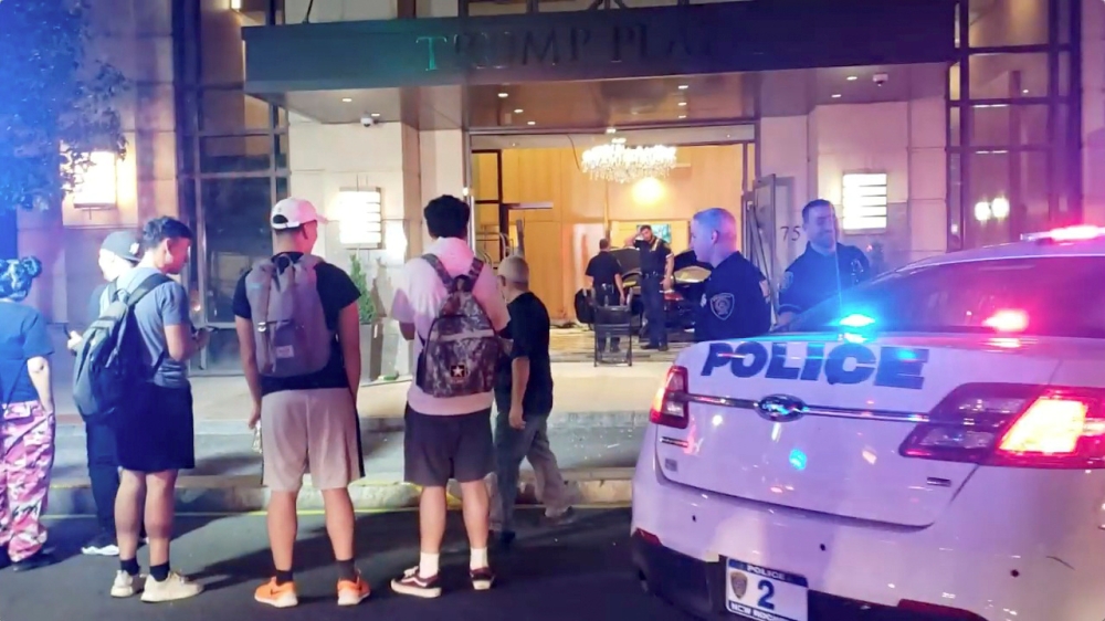 People and police officers stand outside Trump Plaza after a car crashed into the building's lobby in New Rochelle, New York, U.S., September 17, 2019, in this still image from video obtained via social media. Jose Abarca via Reuters