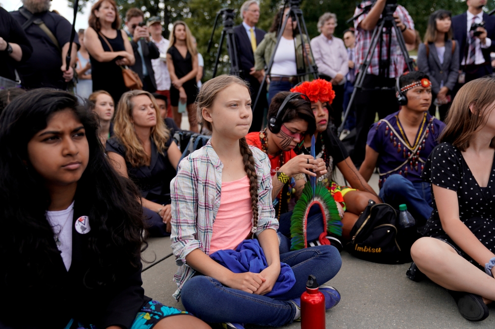 Sixteen year-old Swedish climate activist Greta Thunberg listens to speakers during a climate change demonstration at the US Supreme Court in Washington, September 18, 2019. Reuters/Kevin Lamarque