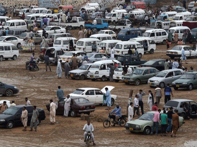 People gather at the Sunday car market in Karachi, Pakistan, July 26, 2015. AFP