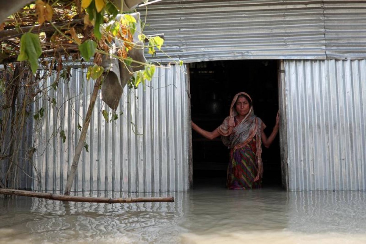 Saju Begum, a flood-affected woman poses for a picture inside her house in Jamalpur, Bangladesh, July 21, 2019. Reuters/Mohammad Ponir Hossain