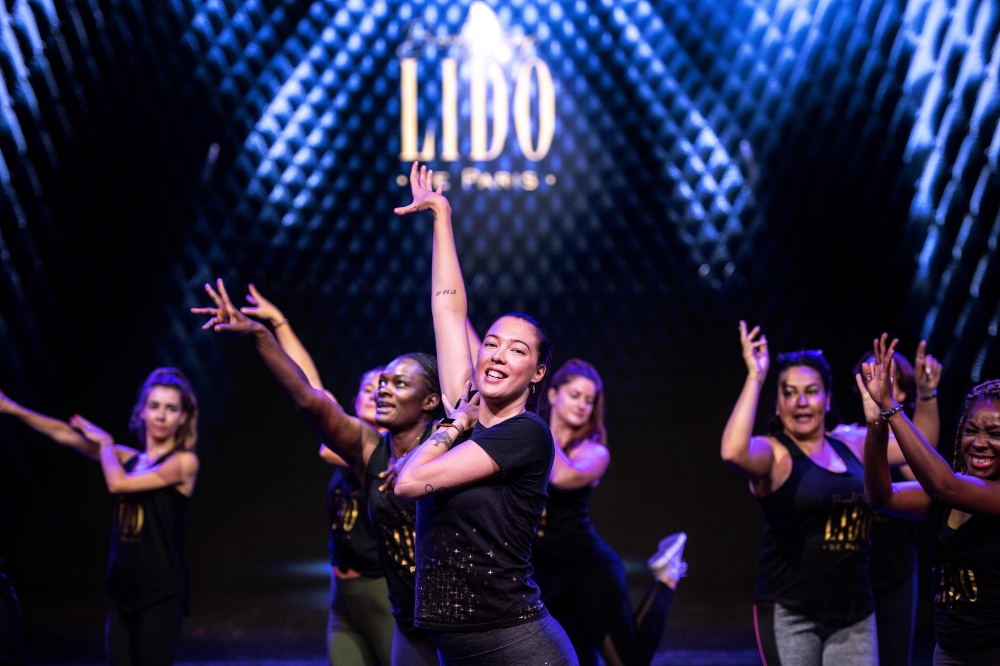 Lido dancer Victoria (C) conducts a 'bootcamp' workshop on the stage of the Lido cabaret in Paris on September 10, 2019. AFP / Christophe Archambault 