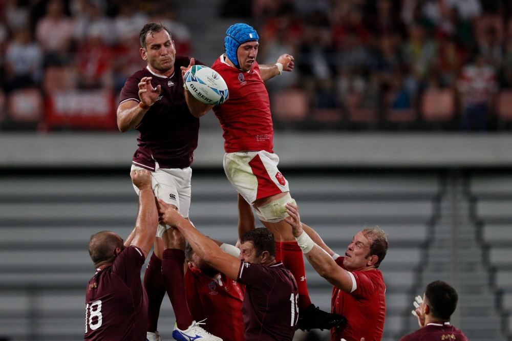 Georgia's lock Giorgi Nemsadze (L) and Wales' flanker Justin Tipuric jump for the ball in a line out during the Japan 2019 Rugby World Cup Pool D match between Wales and Georgia at the City of Toyota Stadium in Toyota City on September 23, 2019. / AFP / A