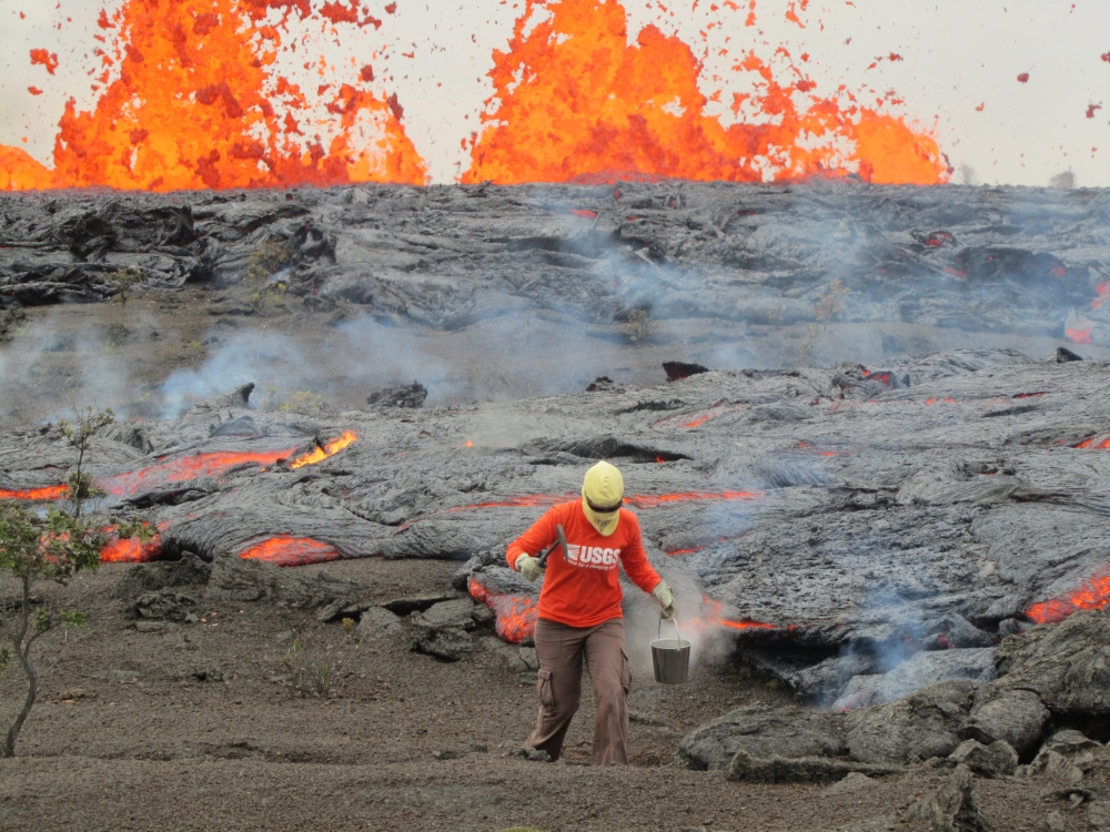 A geologist is collecting sample of molten lava from 2011 Kamoamoa eruption at Kilauea Volcano Hawaii ,US,  (USGS handout via Reuters)