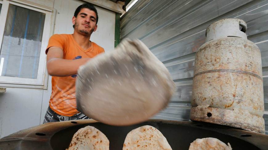 A Syrian refugee makes bread to sell at the Zaatari refugee camp in Mafraq, Jordan, January 8, 2015. Reuters/Muhammad Hamed