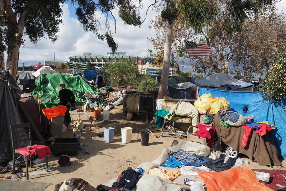 A homeless encampment made of tents and tarps lines the Santa Ana riverbed near Angel Stadium in Anaheim, California, January 25, 2018. AFP / Robyn Beck