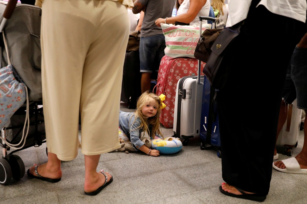 A notice is pictured in the window of a closed-down branch of the global travel group Thomas Cook, three days after the company filed for bankruptcy, in Peterborough, central England on September 26, 2019. AFP / Oli Scarff