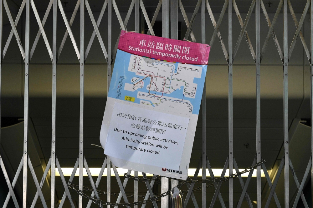A closure notice by officials sits on the gates of the MTR underground rail system in the Admiralty area in Hong Kong on October 1, 2019, after officials closed off numerous stations across the city as intense protests were expected on the 70th anniversar