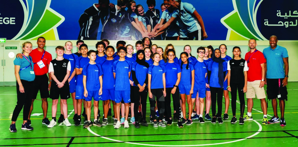 Long jump World Record holder Mike Powell, double-gold medallist at the Worlds, Ashton Eaton, former high jump world champion Stefan Holm and heptathlon double-silver medallist Brianne Theisen-Eaton pose for the students athletes at Doha College during a 