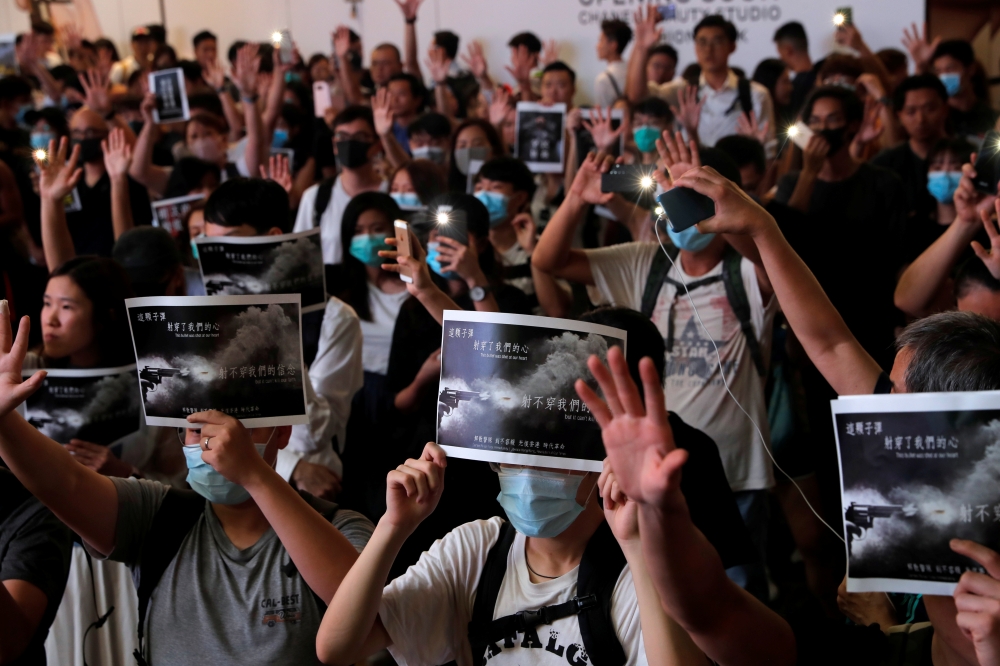 People attend a march in Causeway Bay in solidarity with the student protester who got shot by police with live ammunition in Hong Kong, China October 2, 2019. REUTERS/Susana Vera