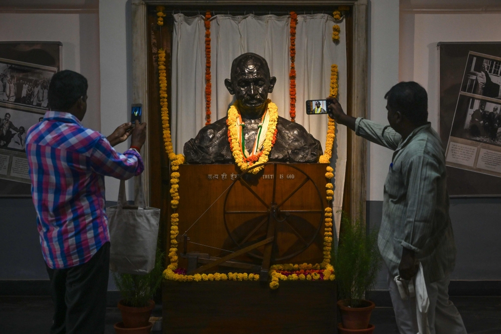 Visitors take a picture of a statue of Indian independence icon Mahatma Gandhi at the National Gandhi Museum, as India marked his 150th birth anniversary, in New Delhi on October 2, 2019. AFP / Money Sharma 