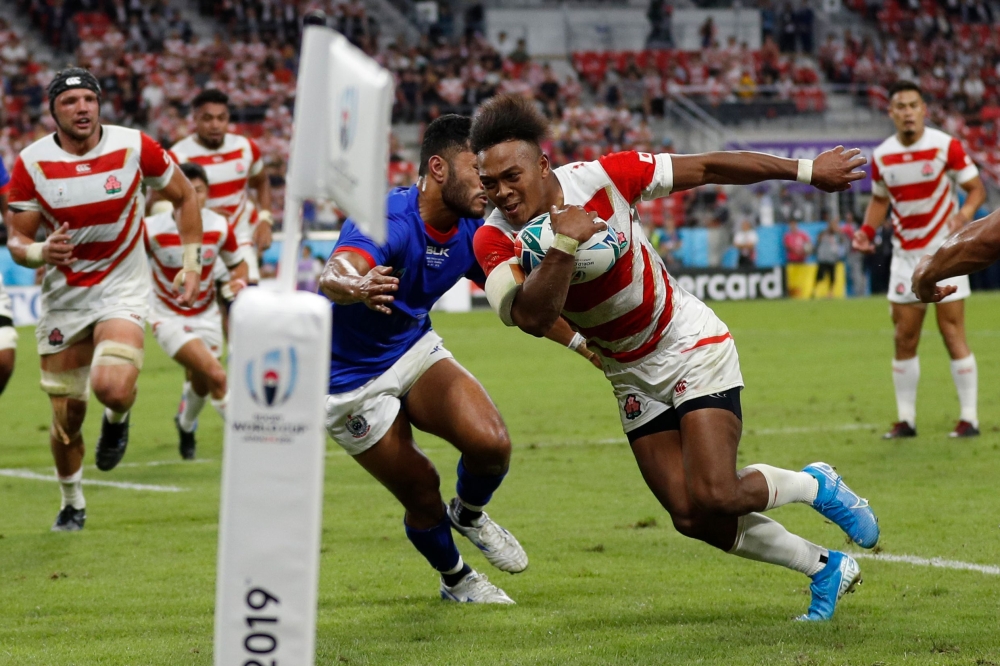 Japan's wing Kotaro Matsushima (R) runs to score a try the Japan 2019 Rugby World Cup Pool A match between Japan and Samoa at the City of Toyota Stadium in Toyota City on October 5, 2019. / AFP / Adrian DENNIS