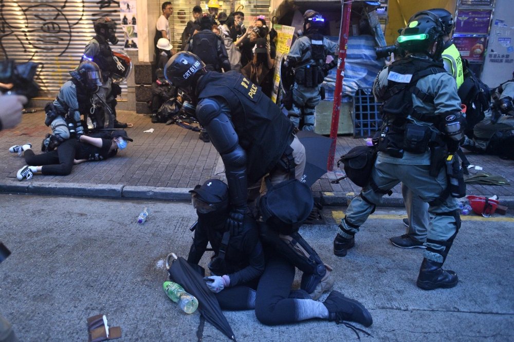 Protesters are detained by Hong Kong police during clashes the Wanchai district in Hong Kong on October 6, 2019. AFP / Mohd RASFAN