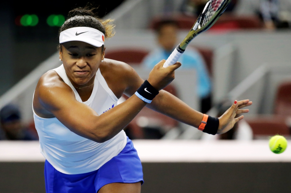 Naomi Osaka of Japan in action against Ashleigh Barty of Australia. REUTERS/Jason Lee

