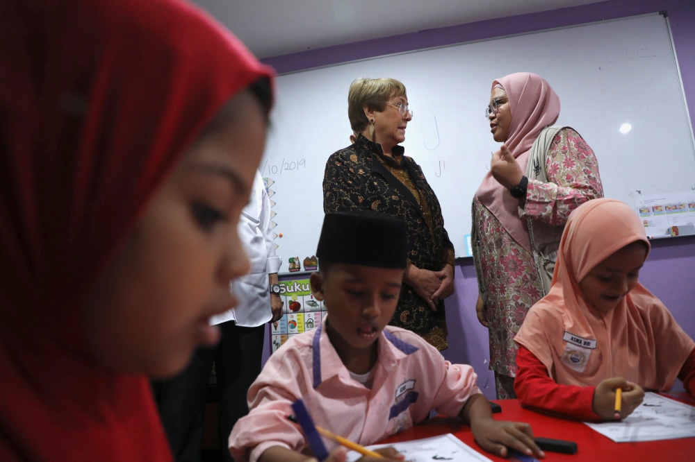 UN High Commissioner for Human Rights Michelle Bachelet talks to a teacher during a visit at the Rohingya Integrated School of Excellence in Kajang, Malaysia. October 4, 2019. Reuters/Lim Huey Teng