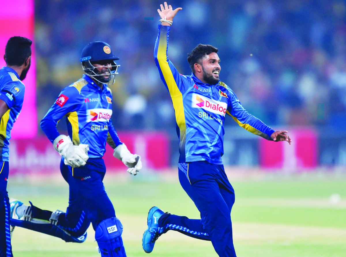 Sri Lanka's spinner Wanindu Hasaranga (R) celebrates with teammates after dismissal of Pakistan's captain Sarfraz Ahmed during the second Twenty20 International cricket match between Pakistan and Sri Lanka at the Gaddafi Cricket Stadium in Lahore on Octob