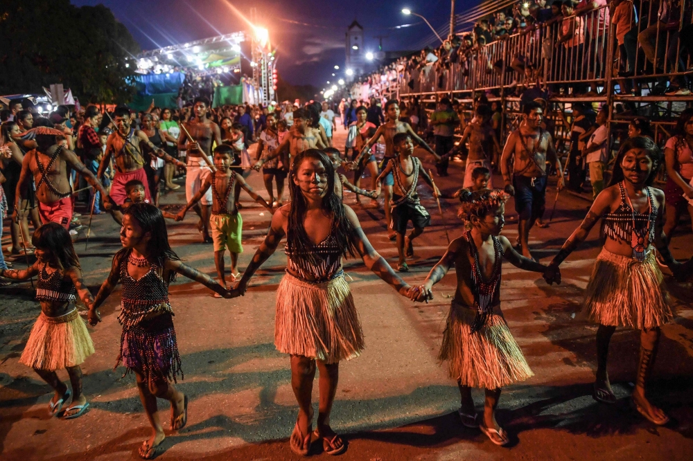 Munduruku indigenous people take part in a parade commemorating the Independence Day, in Itaituba, -a town along a section of the trans-Amazonian highyway-, Para state, Brazil, on September 7, 2019.  AFP / Nelson Almeida 