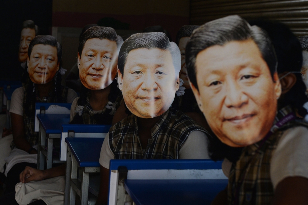 FILE PHOTO: Indian school students wear masks of China's President Xi Jinping in Chennai on October 10, 2019, AFP / ARUN SANKAR
