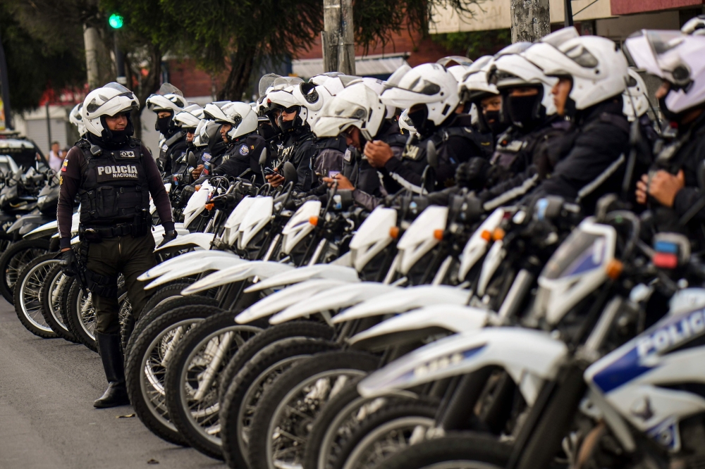 Motorcyclist policemen are deployed in a street in Quito on October 12, 2019, as a curfew took effect during the 10th day of a protest over a fuel price hike ordered by the government to secure an IMF loan.  AFP / Martin Bernetti 
