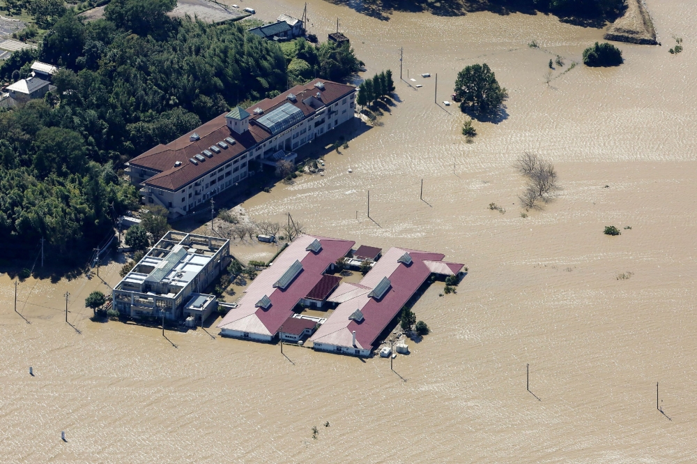 This aerial view shows the flooded Kawagoe Kings Garden nursing home beside the Oppegawa river in Kawagoe, Saitama prefecture on October 13, 2019.  AFP / JIJI PRESS

