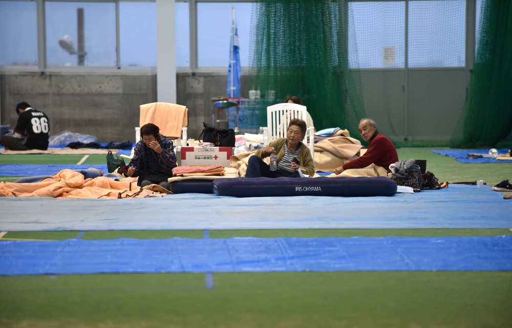 Elderly people rest at an evacuation shelter in Nagano on October 14, 2019, after Typhoon Hagibis crashed into Japan on October 12, unleashing high winds and torrential rain across 36 of the country's 47 prefectures, and triggering landslides and catastro