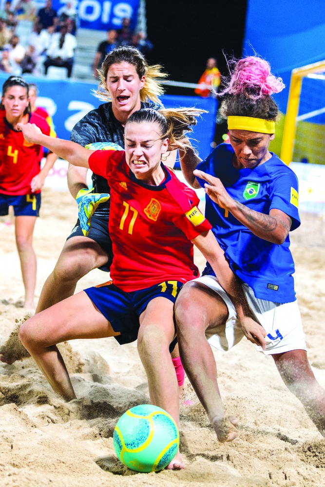 Spanish and Brazilian  players vie for the ball possession during their beach soccer preliminary round match at Katara. Picture: Nassos Triantafyllou / Laurel Photo Services