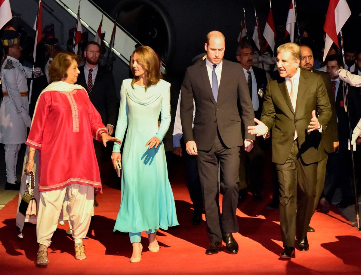 Britain's Prince William, Duke of Cambridge (Center R) and his wife Britain's Catherine, Duchess of Cambridge (Center L) are welcomed by Pakistan's Foreign Minister Shah Mehmood Qureshi (R) upon their arrival at the Pakistan's Nur Khan military airbase in