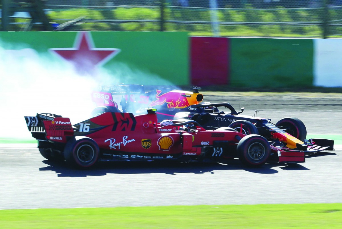 Red Bull’s Dutch driver Max Verstappen (behind) collides with Ferrari’s Monegasque driver Charles Leclerc (front) after the start of the Japanese Grand Prix in Suzuka on Sunday.