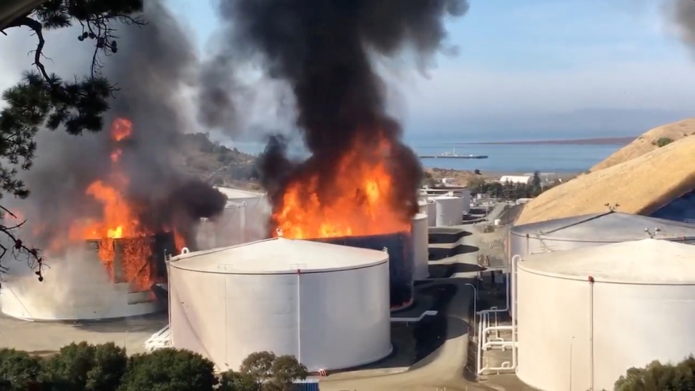 Smoke billows from fire burning in two tanks at a NuStar oil storage facility in Contra Costa County, California, U.S. October 15, 2019, in this still image obtained from a social media video. Courtesy of Napa County Sheriff's Office/Social Media via REUT