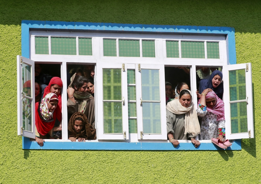 Kashmir women react as they watch the body of Nasir Ahmad, a suspected separatist militant, during his funeral procession after he was killed in a gun battle with Indian soldiers, in Arwani village in Anantnag district October 16, 2019. Reuters/Danish Ism