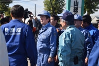 Japan's Prime Minister Shinzo Abe (C) inspects an area hit by Typhoon Hagibis last week in Koriyama, Fukushima prefecture on October 12, 2019. AFP