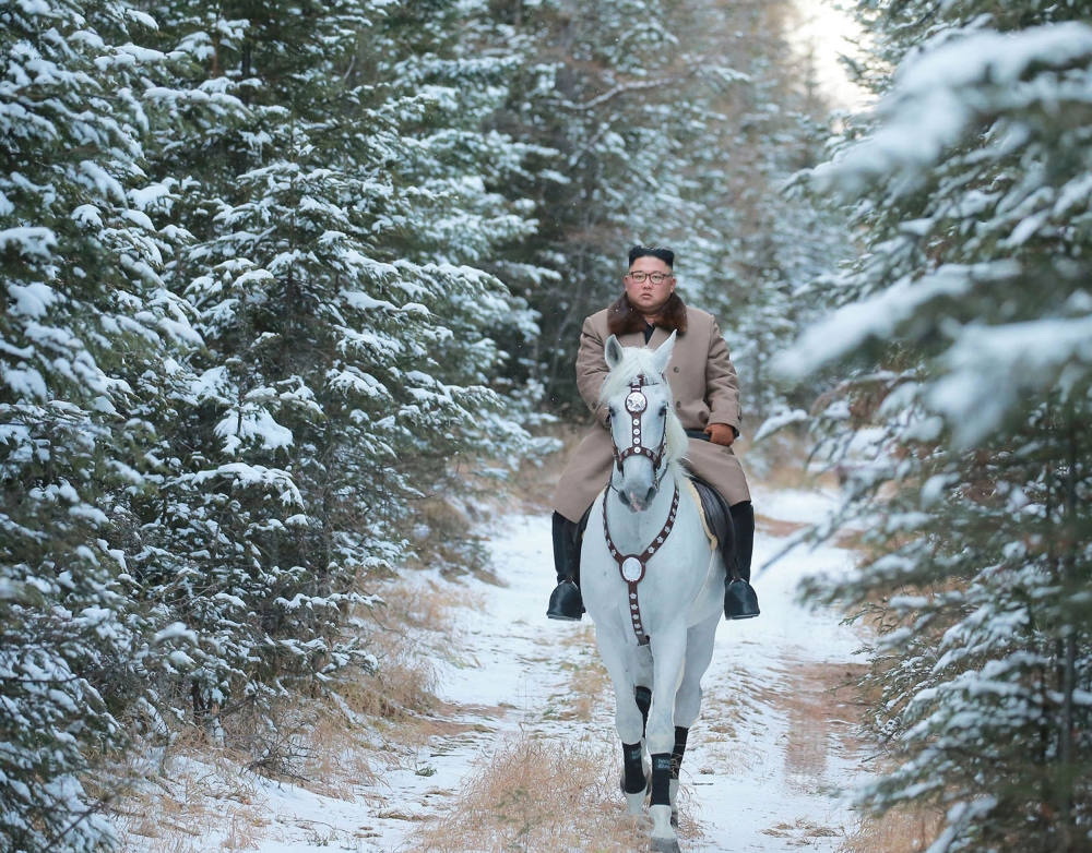 This undated picture released by Korean Central News Agency on October 16, 2019 shows North Korean leader Kim Jong Un riding a white horse amongst the first snow at Mouth Paektu. AFP