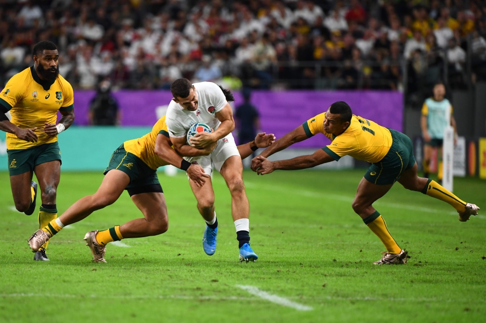 England's wing Jonny May (C) is tackled by Australia's centre Jordan Petaia (2nd L) and Australia's full back Kurtley Beale during the Japan 2019 Rugby World Cup quarter-final match between England and Australia at the Oita Stadium in Oita on October 19,