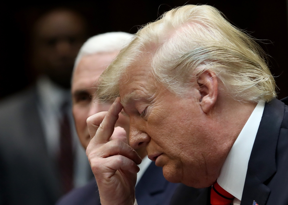 US President Donald Trump (R) and Vice President Mike Pence listen during a conference call with the International Space Station on October 18, 2019 in Washington, DC. Win McNamee/Getty Images/AFP