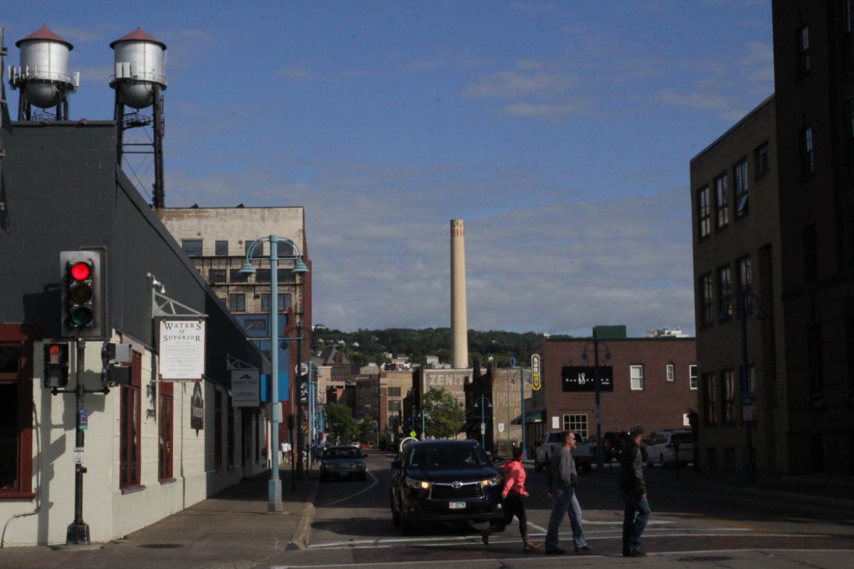 Pedestrians cross a street in Duluth, Minnesota, U.S., on Aug. 24, 2019. Thomson Reuters Foundation/Sebastien Malo