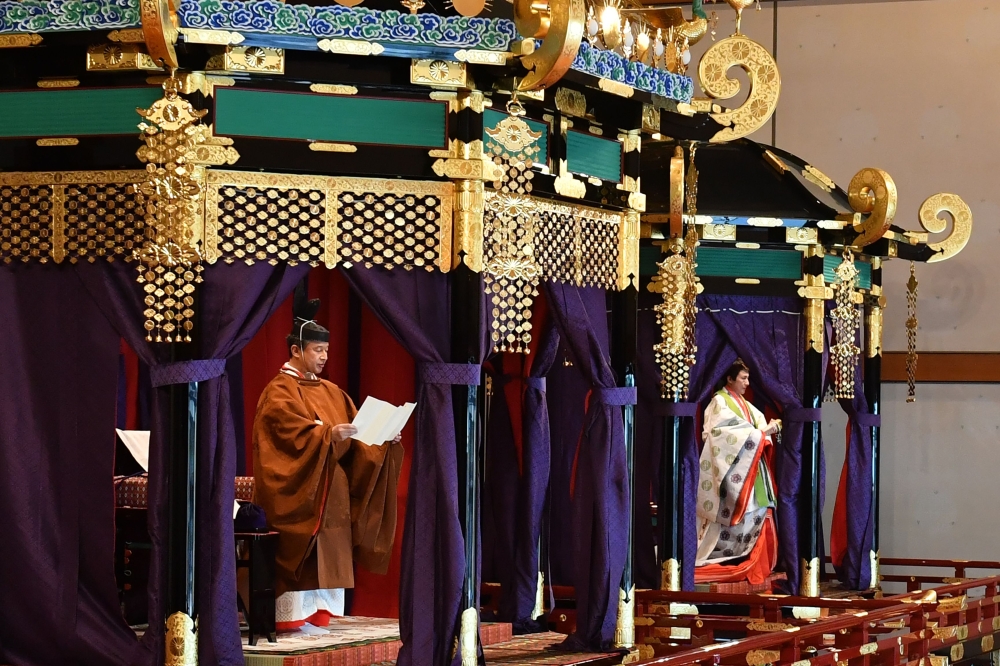 Emperor Naruhito (L) and Empress Masako (R) attend the enthronement ceremony where the emperor officially proclaims his ascension to the Chrysanthemum Throne at the Imperial Palace in Tokyo on October 22, 2019. AFP / POOL / Kazuhiro NOGI
