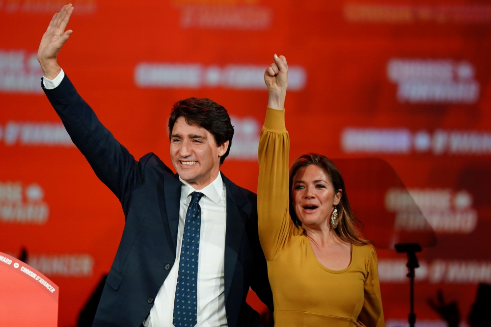 Liberal leader and Canadian Prime Minister Justin Trudeau and his wife Sophie Gregoire Trudeau wave to supporters after the federal election at the Palais des Congres in Montreal, Quebec, Canada October 22, 2019. Reuters/Carlo Allegri