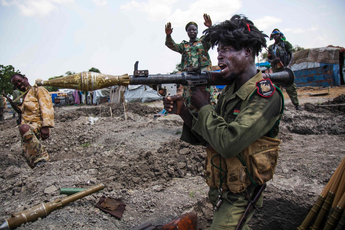 FILE PHOTO: Soldiers of the Sudan People Liberation Army celebrate while standing in trenches in Lelo outside Malakal, northern South Sudan on October 16, 2016. AFP / Albert Gonzalez Farran