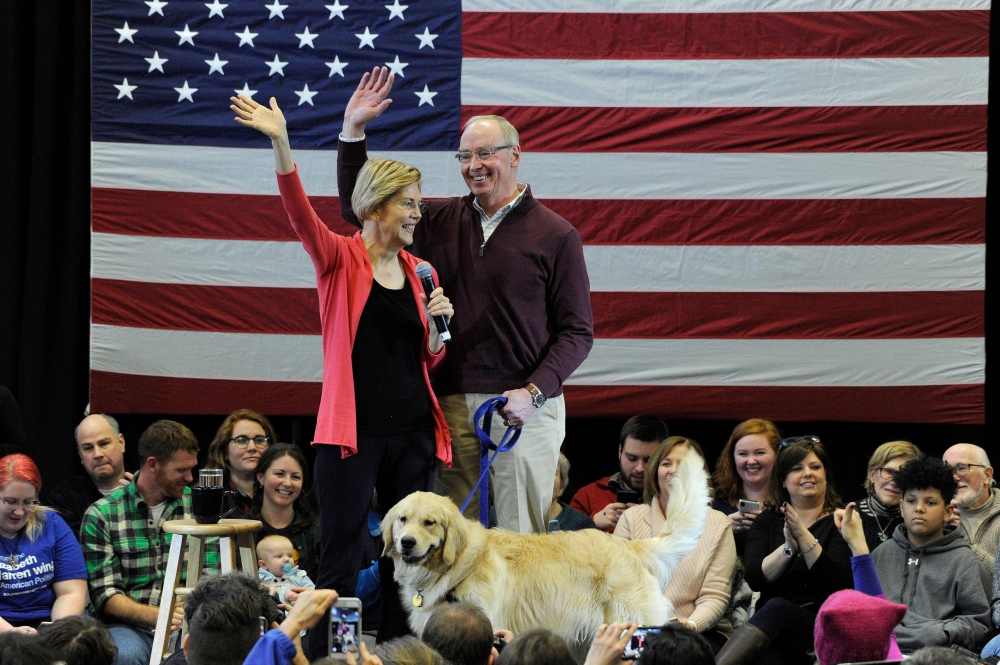 Elizabeth Warren and husband Bruce Mann and their dog Bailey take the stage on January 12, 2019 as part of her exploratory presidential committee at Manchester Community College. AFP / Joseph Prezioso