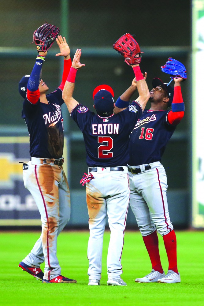 Washington Nationals left fielder Juan Soto (22) and right fielder Adam Eaton (2) and center fielder Victor Robles (16) celebrate after defeating the Houston Astros in game one of the 2019 World Series at Minute Maid Park. Credit: Thomas B. Shea-USA TODAY