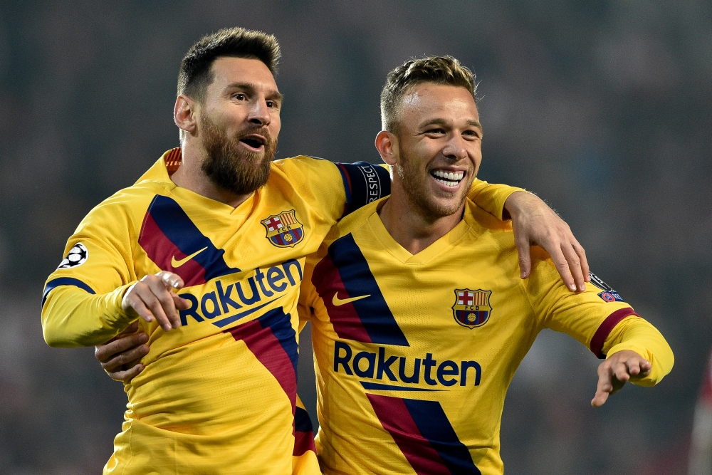 Lionel Messi (L) and Arthur (R) of Barcelona celebrate their goal during the UEFA Champions League Group F soccer match between SK Slavia Praha and FC Barcelona at Sinobo Stadium in Prague, Czech Republic on October 23, 2019. ( Lukas Kabon - Anadolu Agenc
