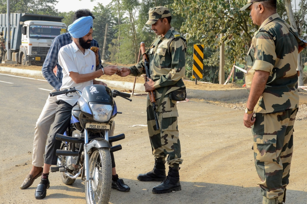 Border Security Force (BSF) personnel check identity documents of motorcyclists at Dera Baba Nanak, some 50 kms from Amritsar on October 24, 2019. AFP / NARINDER NANU