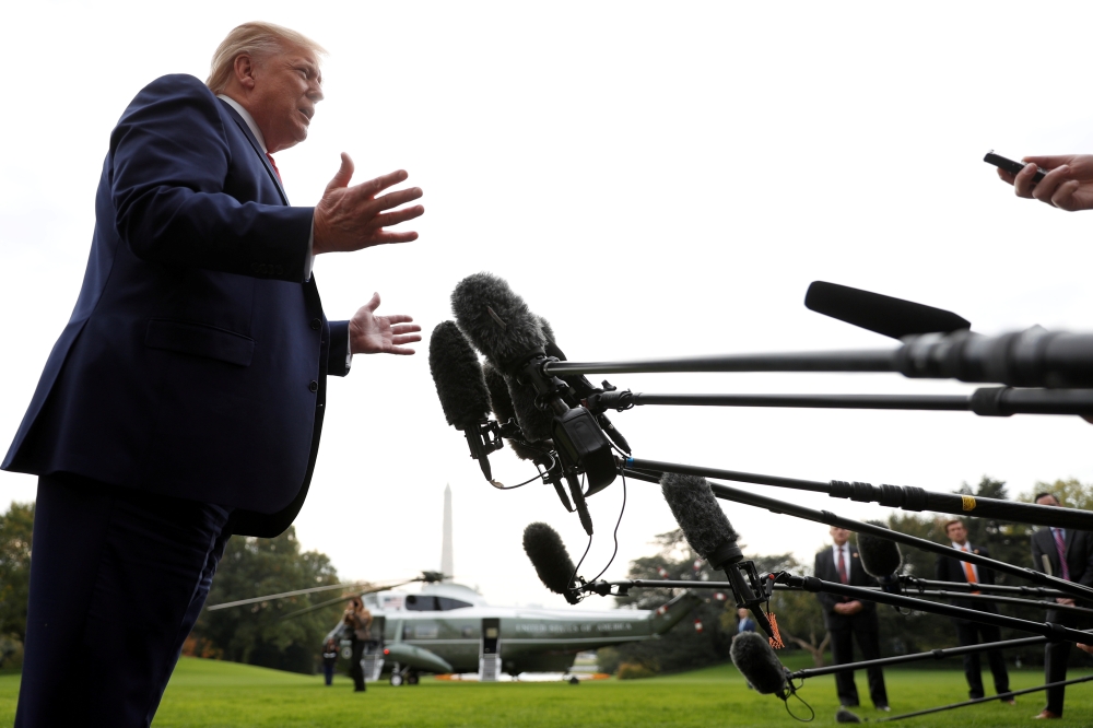 FILE PHOTO: U.S. President Donald Trump speaks to reporters as he departs for travel to South Carolina, at the South Lawn of the White House in Washington, U.S., October 25, 2019. REUTERS/Tom Brenner
