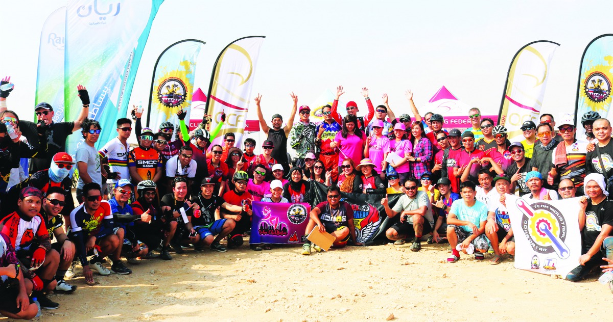 Riders and officials pose for a group photo after the opening round of MTB racing season held in Al Khor. 