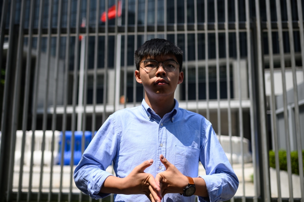In this file photo taken on September 28, 2019 pro-democracy activist and South Horizons Community Organiser Joshua Wong stands in front of the Central Government Complex before the announcement of his run for 2019 District Council elections in Hong Kong.