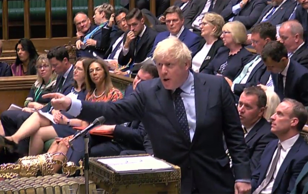 A video grab from footage broadcast by the UK Parliamentary Recording Unit shows Prime Minister Boris Johnson gestures toward the opposition benches on September 3, 2019.