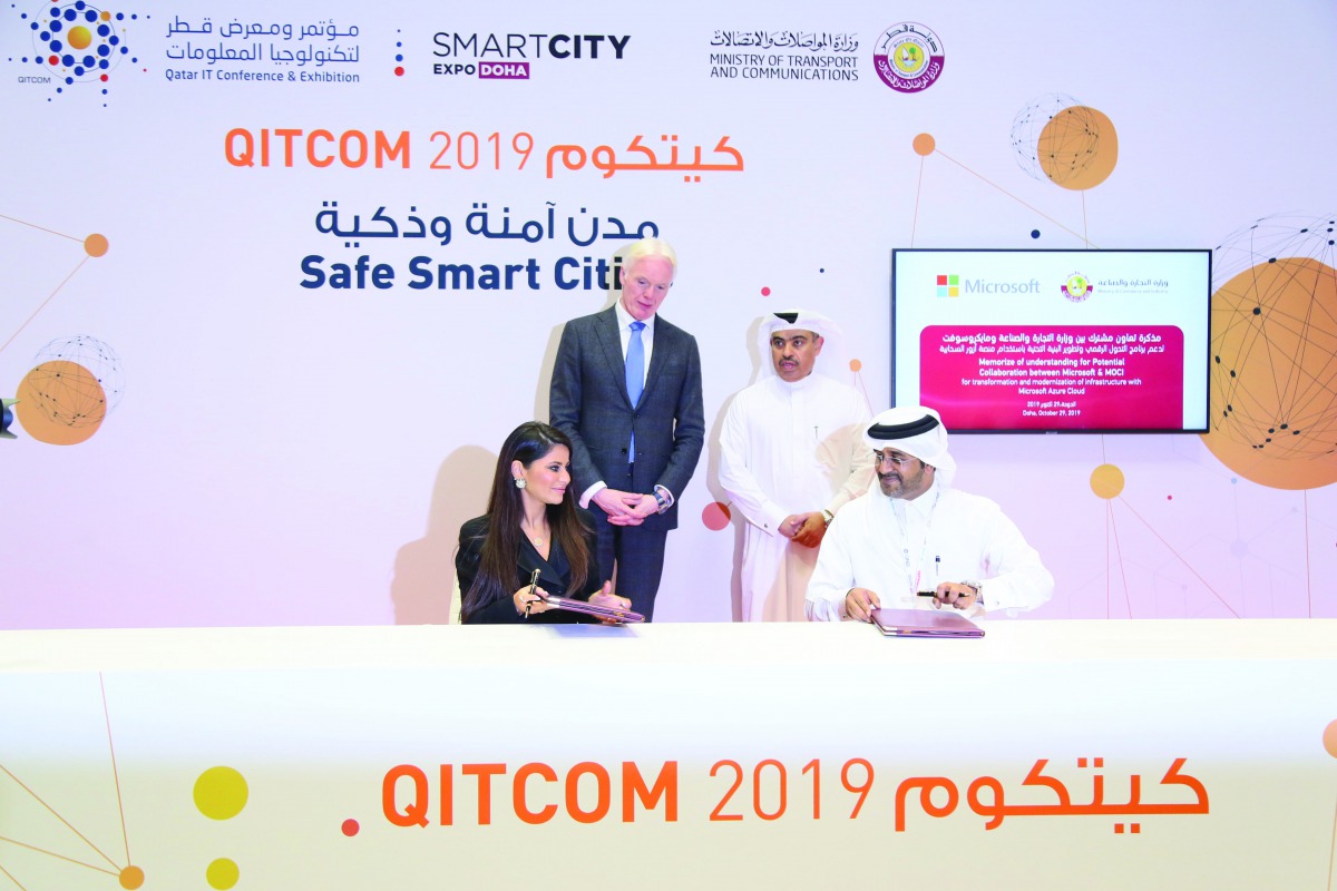 Minister of Commerce and Industry, H E Ali bin Ahmed Al Kuwari (standing right), Abdulla Ahmad Al Ali (right), Director of Information Technology at MoCI, with Lana Khalaf (left), Country Manager at Microsoft Qatar, during the signing ceremony at QITCOM, 