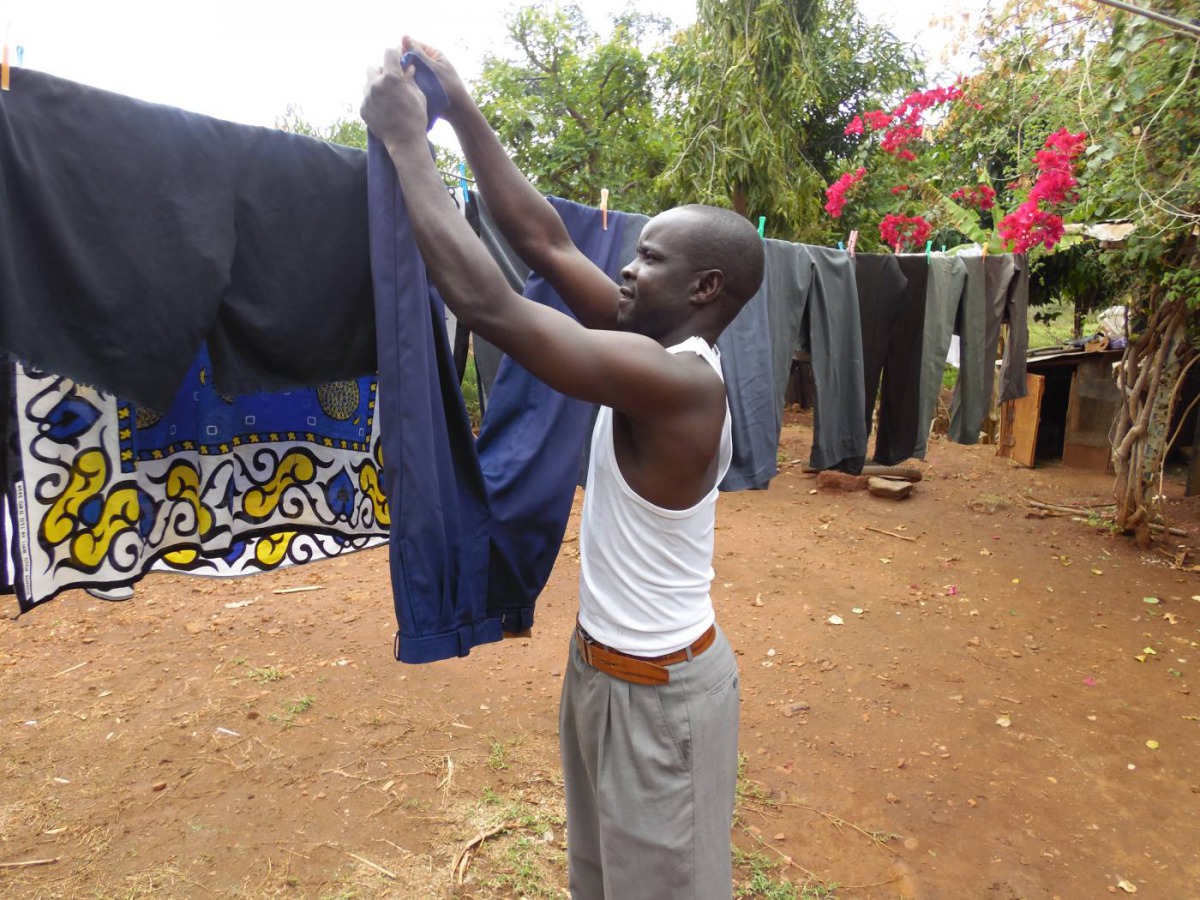 Moses Njiru hangs laundry to dry at his home in Ishiara, in Kenya's Embu County, October 12, 2019. Thomson Reuters Foundation/Carorline Wambui